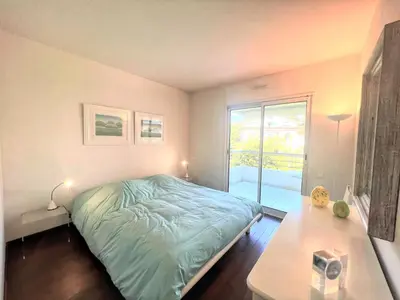 a bedroom with a bed and a table and a window at Ambre d' Or apartment by Welcome to Cannes in Cannes