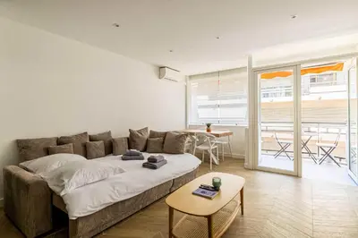 a living room with a couch and a table at Cozy renovated apartment - close to Martinez Hotel in Cannes