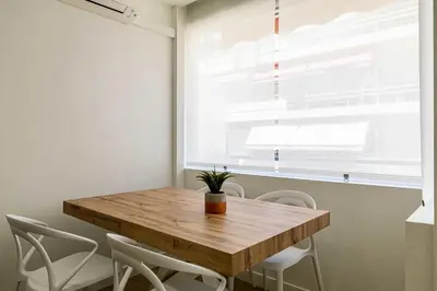a wooden table and chairs in a room with a window at Cozy renovated apartment - close to Martinez Hotel in Cannes
