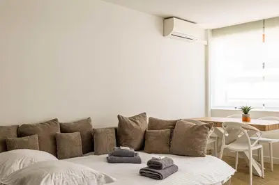 a living room with a couch and a table at Cozy renovated apartment - close to Martinez Hotel in Cannes
