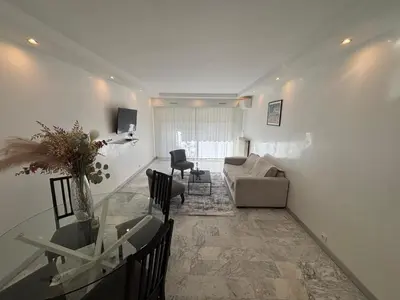 a living room with a glass table and a couch at Mathéo in Cannes