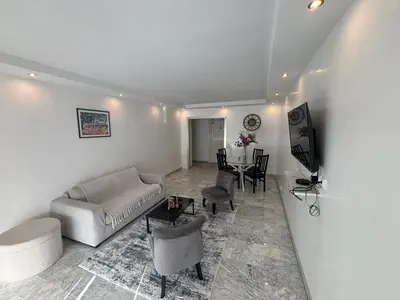a living room with a couch and a table at Mathéo in Cannes