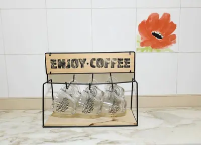 a sign that reads enjoy coffee sitting on a counter at Mathéo in Cannes