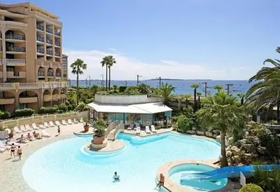a swimming pool at a hotel with a resort at magnifique APPARTEMENT vue mer Parking Piscine Plage Climatisé in Cannes