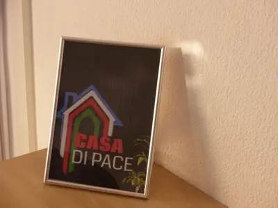 a framed picture of a pizza place sign on a table at magnifique APPARTEMENT vue mer Parking Piscine Plage Climatisé in Cannes