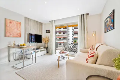 a living room with a couch and a table at Downtown Cannes Modern 1-Br Apartment in Cannes