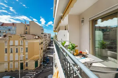 an apartment balcony with a view of a city at Downtown Cannes Modern 1-Br Apartment in Cannes