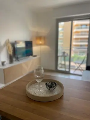 a wine glass sitting on top of a wooden table at Studio Balcon Centre Plage in Cannes