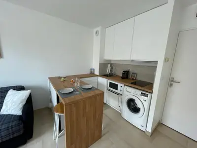 a small kitchen with a washing machine and a washer at Studio Balcon Centre Plage in Cannes