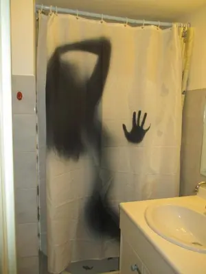 a person in a shower curtain in a bathroom at Studio au calme à 5mn de la mer et de toutes attractions de la ville in Cannes