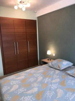 a bedroom with a bed and a dresser and a cabinet at Appartement Mimosa Croisette in Cannes