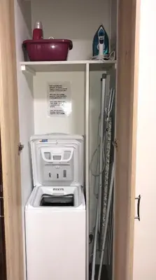 a refrigerator with a washer and dryer in a kitchen at Appartement Mimosa Croisette in Cannes