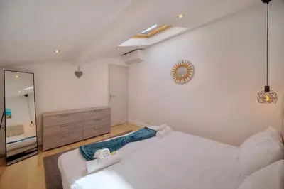 a bedroom with two white beds and a mirror at IMMOGROOM - Heart of the Suquet - City center - Modern in Cannes