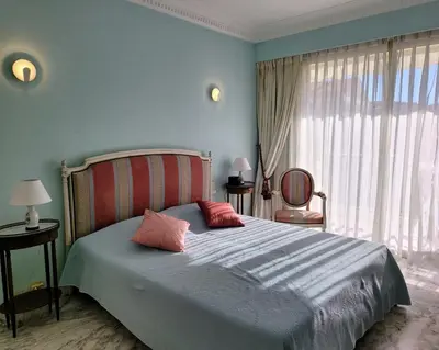 a bedroom with a bed with two pillows on it at LA PRESQU'ILE T2 PALM BEACH MOURE ROUGE in Cannes