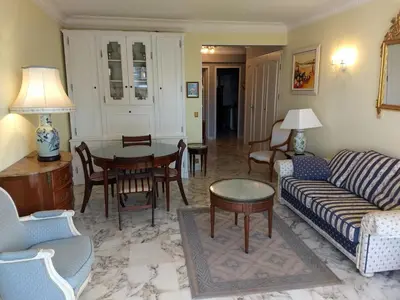 a living room with a couch and a table at LA PRESQU'ILE T2 PALM BEACH MOURE ROUGE in Cannes