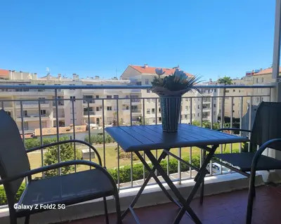 a blue table with a vase on a balcony at LA PRESQU'ILE T2 PALM BEACH MOURE ROUGE in Cannes