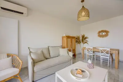 a living room with a couch and a table at Cannes Californie Beautiful Apt with Sea View in Cannes
