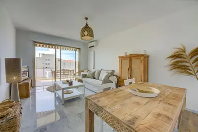 a living room with a table and a couch at Cannes Californie Beautiful Apt with Sea View in Cannes