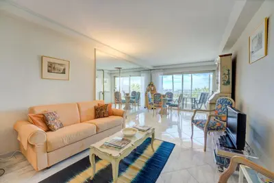 a living room with a couch and a table at Croisette, Amazing Beach Views, 1-bed Apt in Cannes