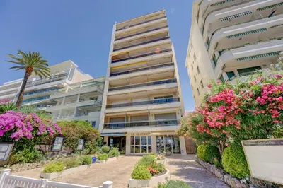 a tall building with flowers in front of it at Croisette, Amazing Beach Views, 1-bed Apt in Cannes