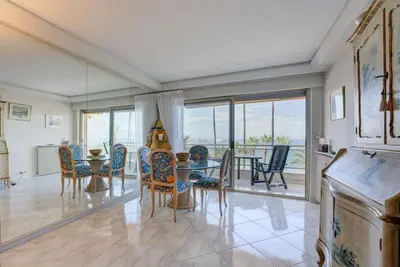a dining room with a table and chairs at Croisette, Amazing Beach Views, 1-bed Apt in Cannes