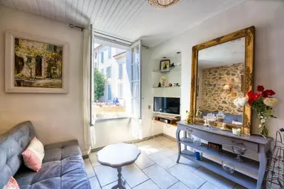 a living room with a couch and a mirror at NEW 2-bed Central Cannes Apt in Cannes