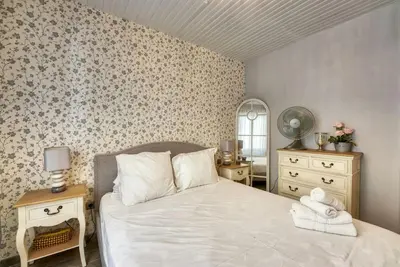 a bedroom with a bed and a dresser and a mirror at NEW 2-bed Central Cannes Apt in Cannes