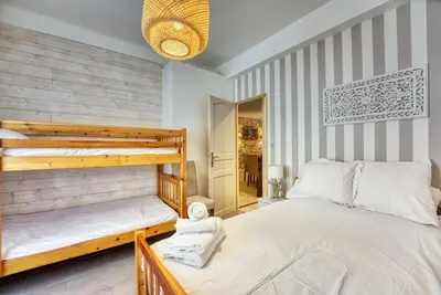 a bedroom with two bunk beds and a mirror at NEW 2-bed Central Cannes Apt in Cannes
