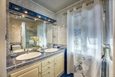 a bathroom with two sinks and a shower at NEW 2-bed Central Cannes Apt in Cannes