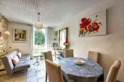 a living room with a table and chairs at NEW 2-bed Central Cannes Apt in Cannes