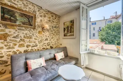 a living room with a couch and a window at NEW 2-bed Central Cannes Apt in Cannes