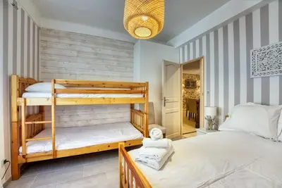 a bedroom with two bunk beds and a hallway at NEW 2-bed Central Cannes Apt in Cannes