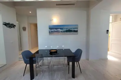 a dining room with a black table and chairs at 06DI Cannes Hoche in Cannes