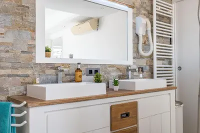 a bathroom with two sinks and a mirror at Penthouse Duplex with Rooftop Terrace in Cannes