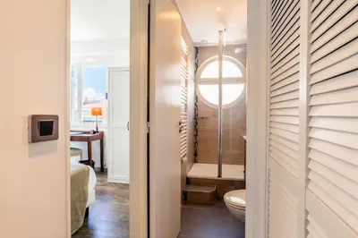 a bathroom with a toilet and a sink in a room at Penthouse Duplex with Rooftop Terrace in Cannes