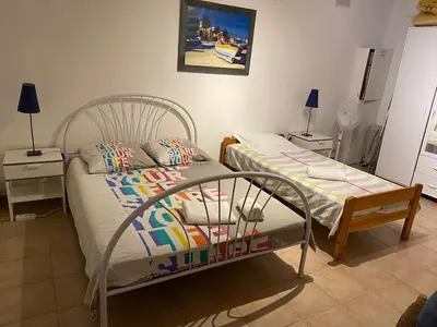 a bedroom with two beds and two night stands at Villa Riviera in Le Cannet