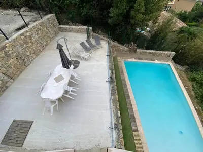 an overhead view of a swimming pool with chairs and a table at Villa Riviera in Le Cannet