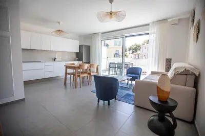 a kitchen and living room with a couch and a table at Les Terrasses De Forville by Connexion in Cannes