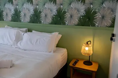 a bedroom with a bed and a lamp on a table at Les Terrasses De Forville by Connexion in Cannes