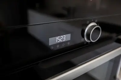 a close up of an oven with a clock on it at Les Terrasses De Forville by Connexion in Cannes
