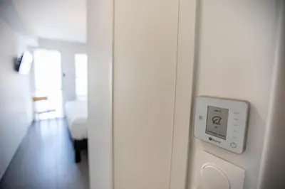 a room with a clock on the wall at Les Terrasses De Forville by Connexion in Cannes