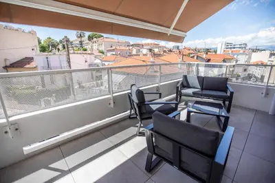 a balcony with chairs and a view of a city at Les Terrasses De Forville by Connexion in Cannes