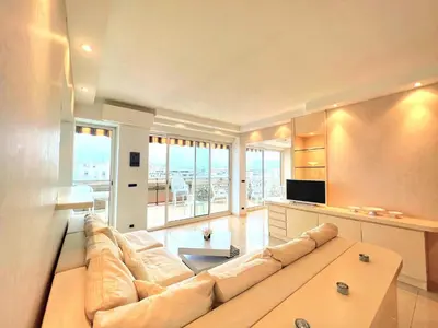 a large living room with a couch and a tv at Colony apartment with parking, by Welcome to Cannes in Cannes