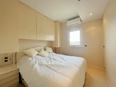 a bedroom with a bed with white sheets and a window at Colony apartment with parking, by Welcome to Cannes in Cannes