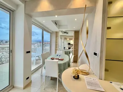 a room with a table and chairs and a balcony at Colony apartment with parking, by Welcome to Cannes in Cannes