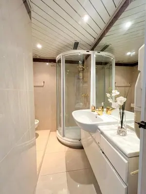 a white bathroom with a shower and a sink at Colony apartment with parking, by Welcome to Cannes in Cannes