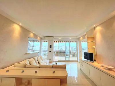a large living room with a couch and a tv at Colony apartment with parking, by Welcome to Cannes in Cannes