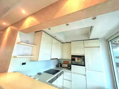 a kitchen with white cabinets and a large window at Colony apartment with parking, by Welcome to Cannes in Cannes