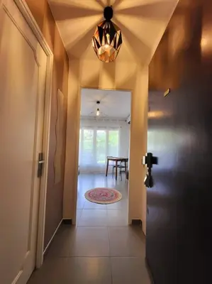 a hallway with a door and a room with a table at Cosy Studio à Cannes 8 min de la Croisette in Cannes