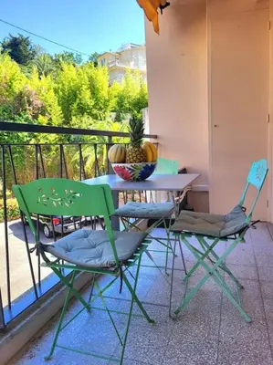a table and two chairs on a balcony at Cosy Studio à Cannes 8 min de la Croisette in Cannes